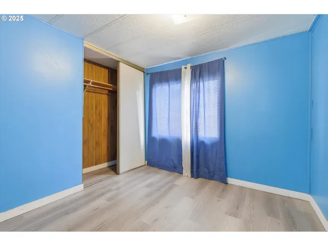 an empty room with wooden floor