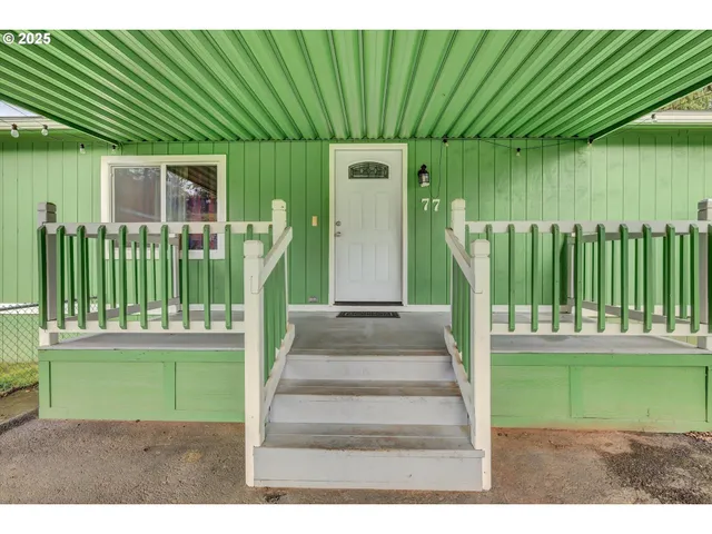 a front view of a house with a garden and plants