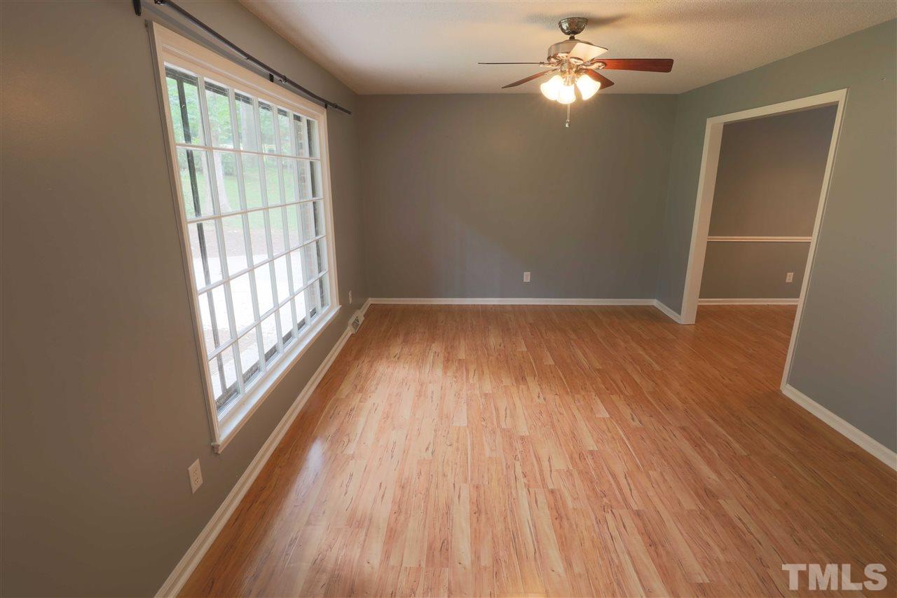 1609 Baker Road Raleigh, NC 27607 - Photo 5 of 22 wooden floor in an empty room with a window