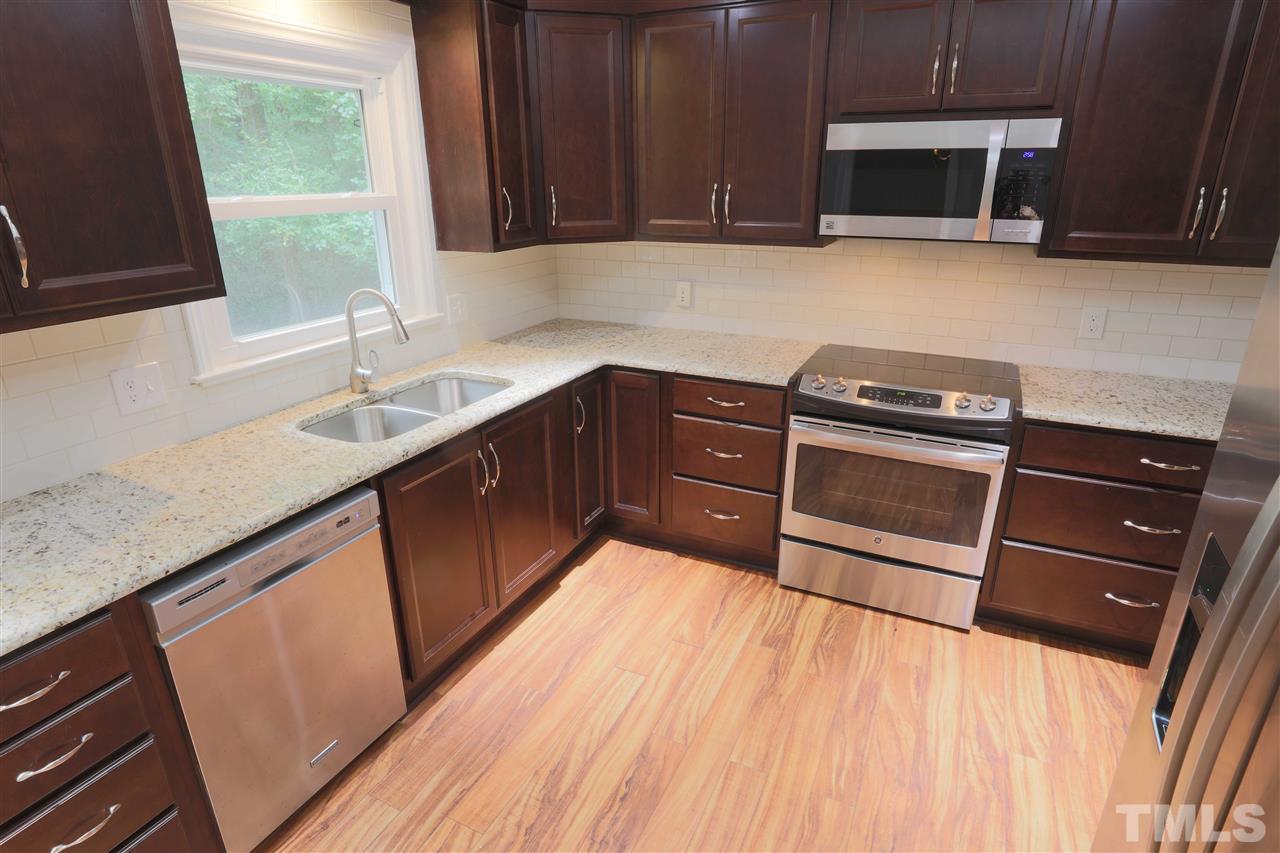 1609 Baker Road Raleigh, NC 27607 - Photo 8 of 22 a kitchen with stainless steel appliances granite countertop a sink stove and microwave