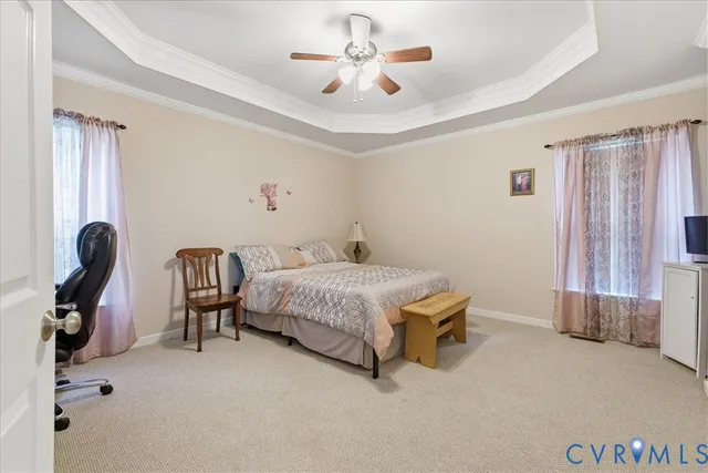 a spacious bedroom with a bed and a chandelier