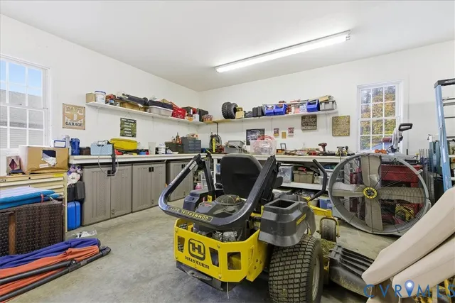 a room with gym equipment and wooden floor