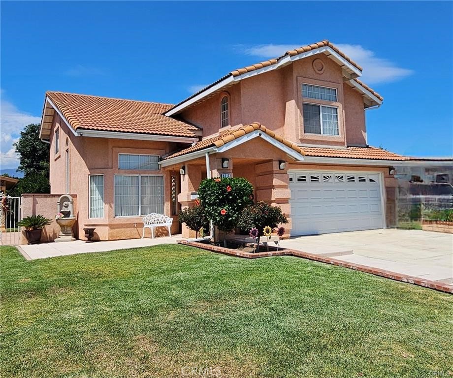 a front view of a house with a yard and garage