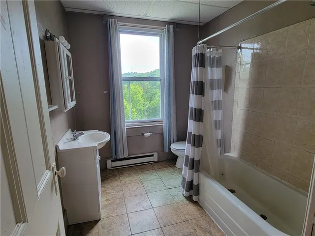 a bathroom with a bathtub and toilet