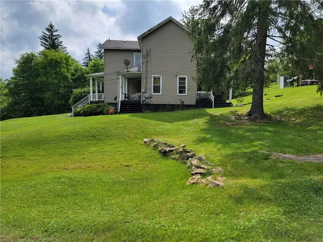 a view of a house with a backyard porch and sitting area