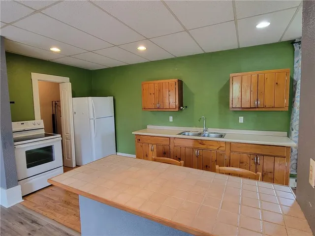 a kitchen with stainless steel appliances a refrigerator sink and stove