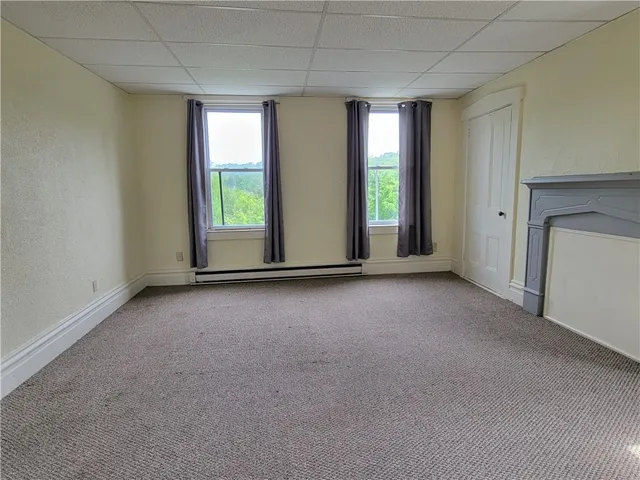 an empty room with windows and closet