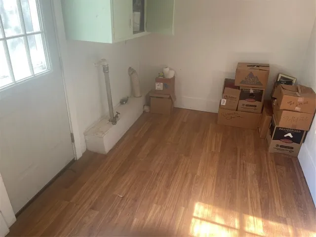 a view of a room with wooden floor and windows