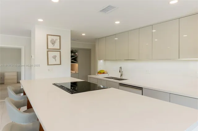 a kitchen with a sink dishwasher a refrigerator and cabinets