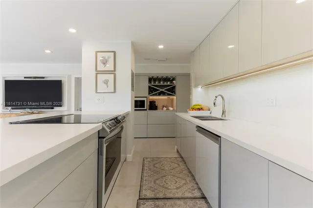 a kitchen with a sink and a stove top oven