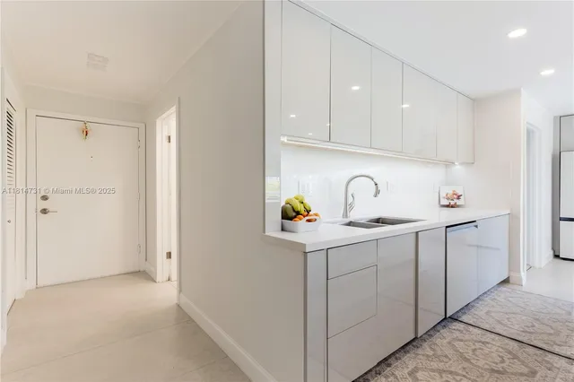 a view of cabinets a sink and dishwasher with wooden cabinets