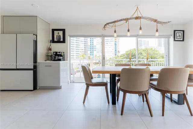 a dining room with furniture a chandelier and wooden floor