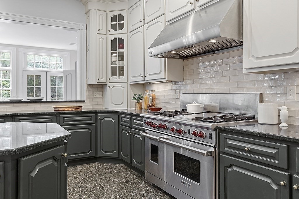 451 Wellesley Street Weston, MA 02493 - Photo 11 of 41 a kitchen with stainless steel appliances granite countertop a stove and a sink