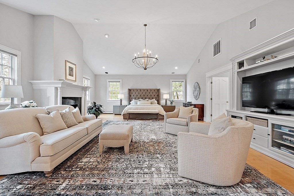 451 Wellesley Street Weston, MA 02493 - Photo 21 of 41 a living room with furniture a flat screen tv and a chandelier