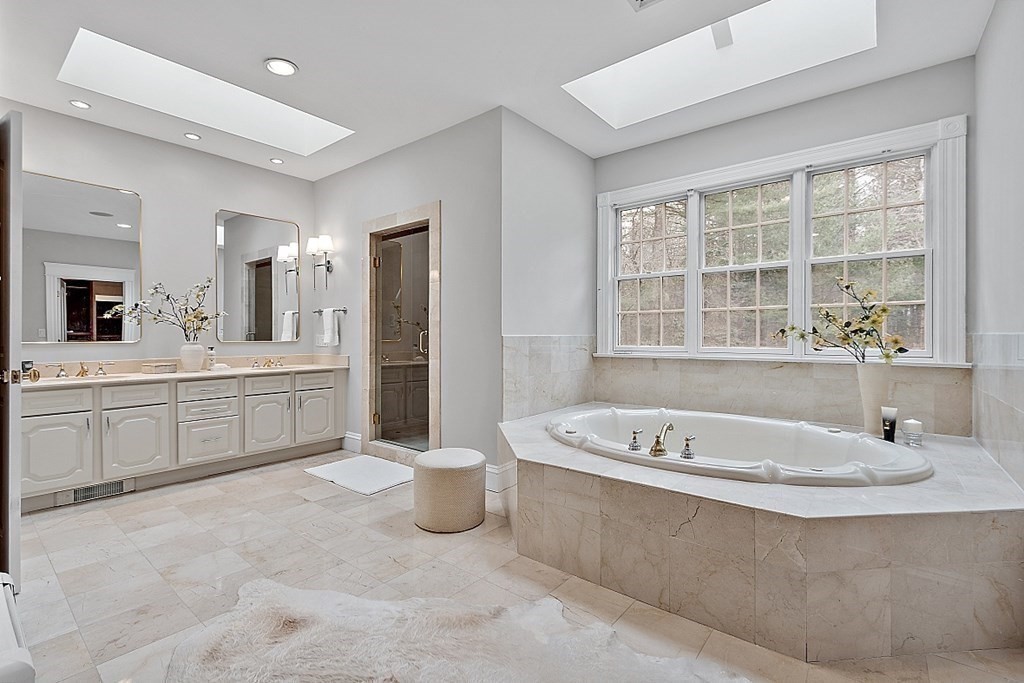 451 Wellesley Street Weston, MA 02493 - Photo 25 of 41 a bathroom with a tub a sink and a window