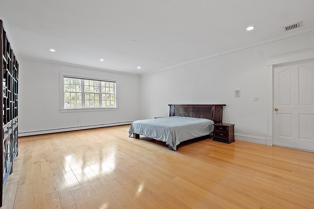 451 Wellesley Street Weston, MA 02493 - Photo 26 of 41 a bedroom with a large bed and a window