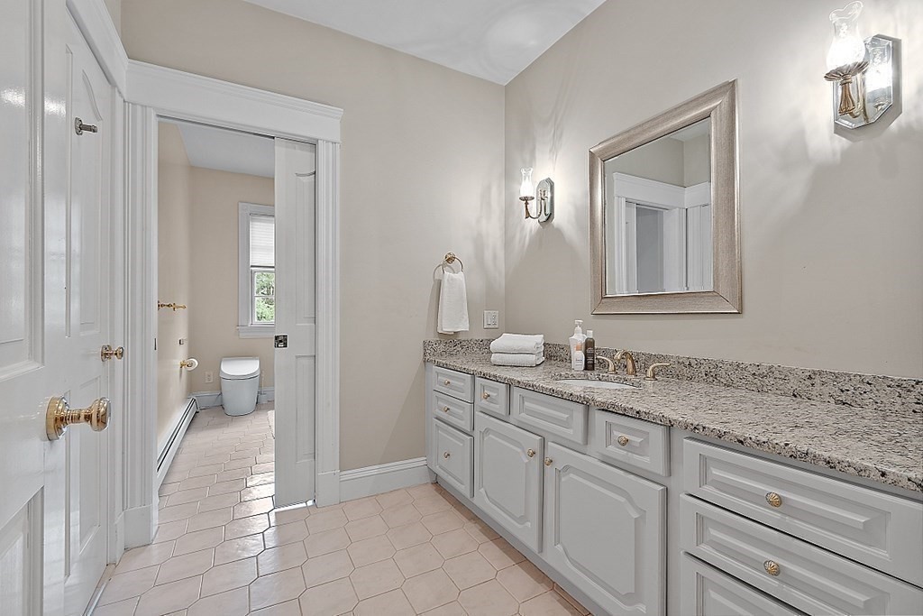 451 Wellesley Street Weston, MA 02493 - Photo 27 of 41 a bathroom with a granite countertop sink mirror and toilet