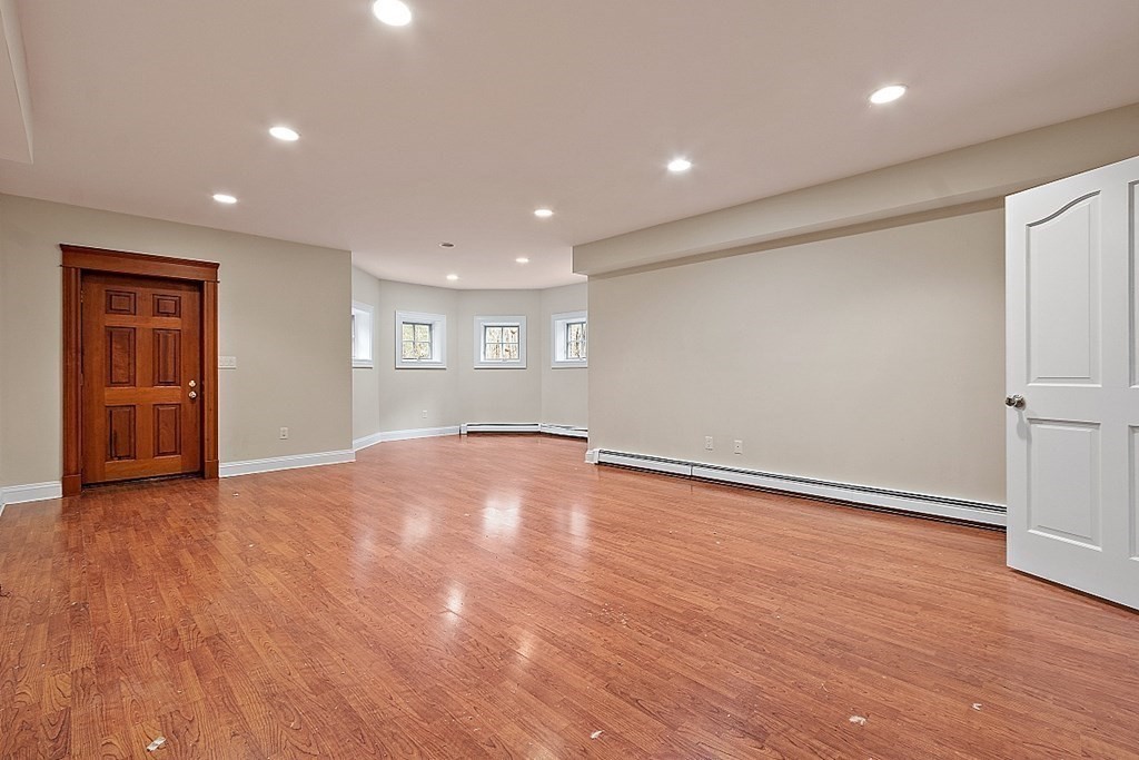 451 Wellesley Street Weston, MA 02493 - Photo 37 of 41 a view of empty room with wooden floor and entryway