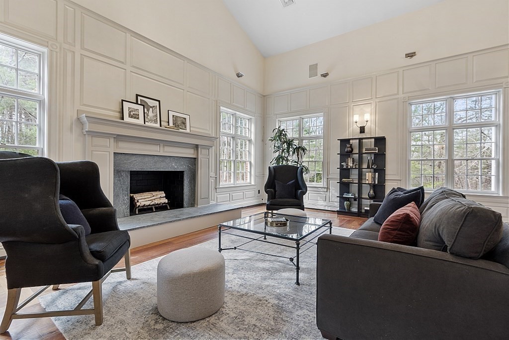 451 Wellesley Street Weston, MA 02493 - Photo 6 of 41 a living room with furniture a flat screen tv and a fireplace