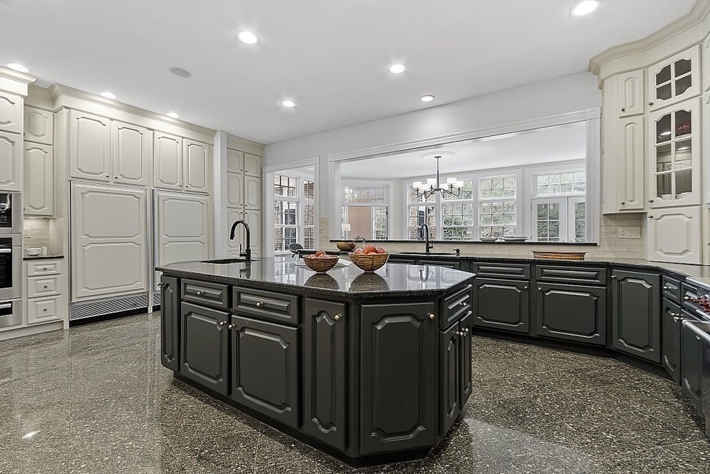 451 Wellesley Street Weston, MA 02493 - Photo 9 of 41 a kitchen with kitchen island granite countertop a sink appliances and cabinets