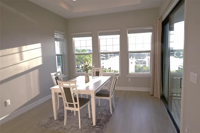 a view of a dining room with furniture and a window