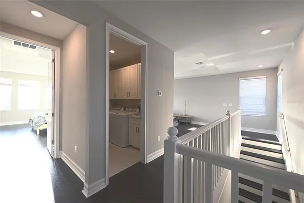 a view of hallway with livingroom and stairs