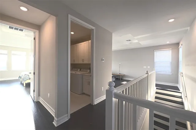 a view of hallway with livingroom and stairs