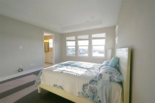 a bed sitting in a bedroom next to a window