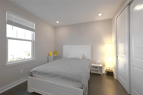 a bedroom with a bed and a window