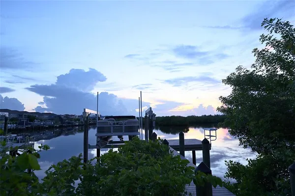 a view of a lake with a house in the background