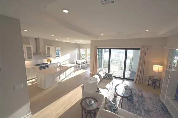 a very nice looking dining room with kitchen island furniture a large window and a fireplace
