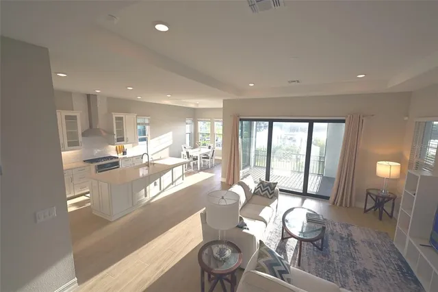 a very nice looking dining room with kitchen island furniture a large window and a fireplace