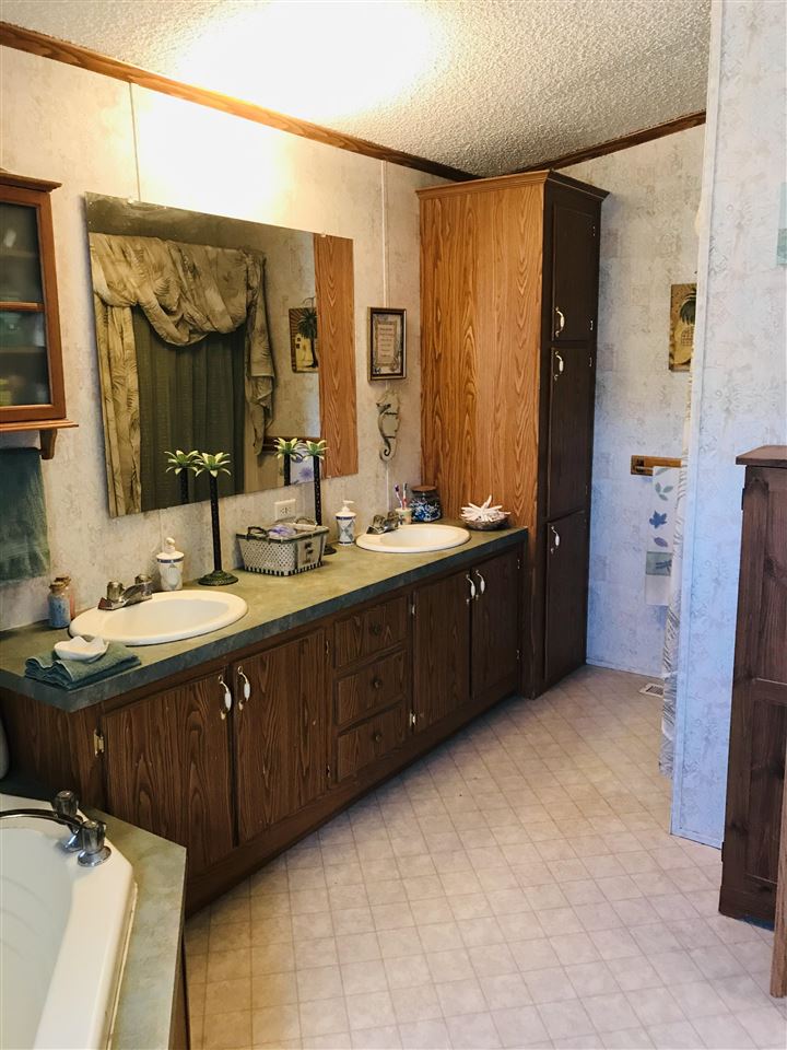 935 R Road Mack, CO 81525 - Photo 4 of 22 a bathroom with a double vanity sink and a mirror