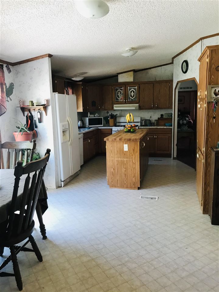 935 R Road Mack, CO 81525 - Photo 8 of 22 a kitchen with stainless steel appliances kitchen island granite countertop a refrigerator and a stove