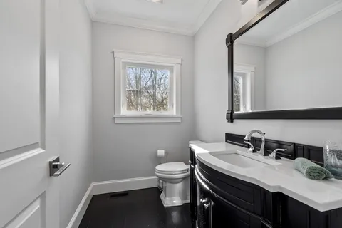 a bathroom with a granite countertop sink toilet a mirror and a tub