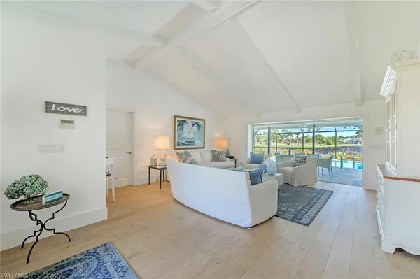 a living room with furniture large window and a table