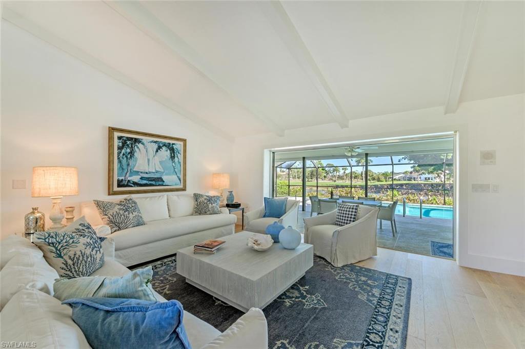 239 Torrey Pines Point Naples, FL 34113 - Photo 15 of 46 a living room with furniture and a large window