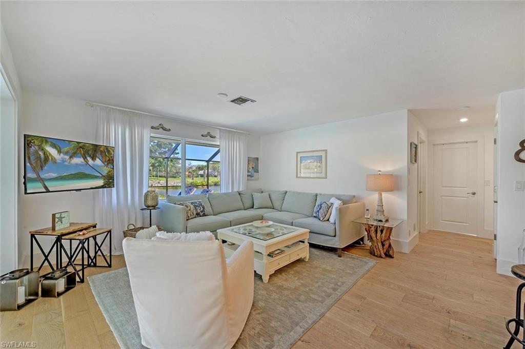 239 Torrey Pines Point Naples, FL 34113 - Photo 20 of 46 a living room with furniture and a flat screen tv