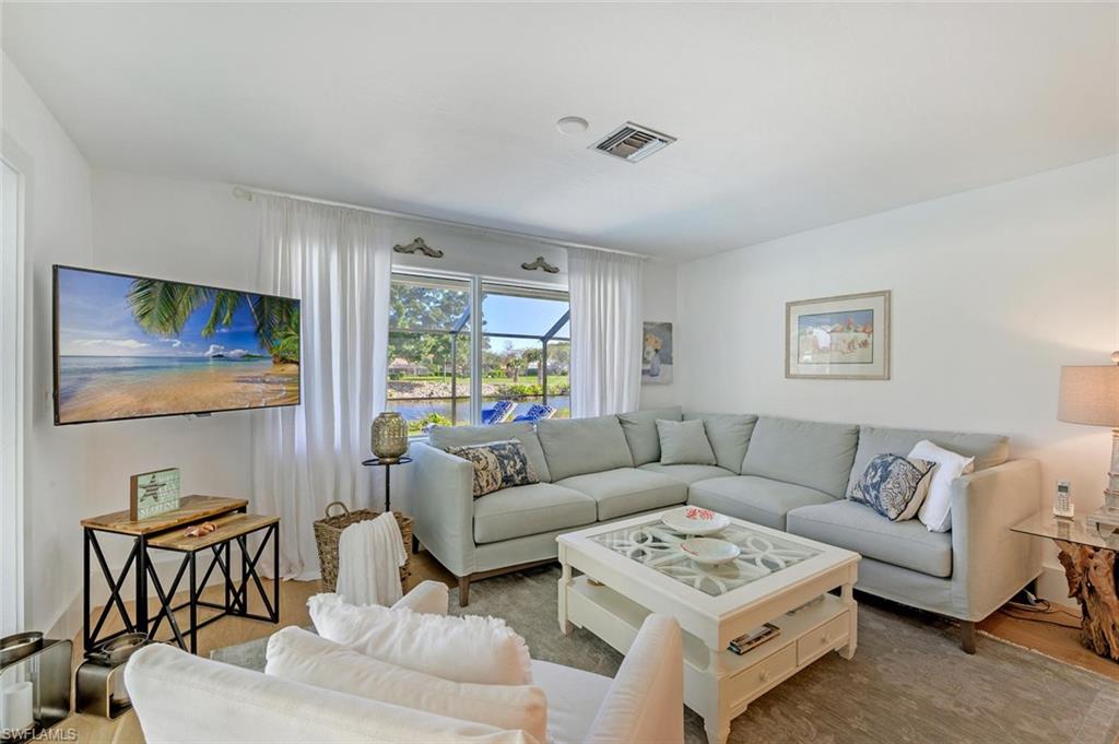 239 Torrey Pines Point Naples, FL 34113 - Photo 21 of 46 a living room with furniture and a flat screen tv