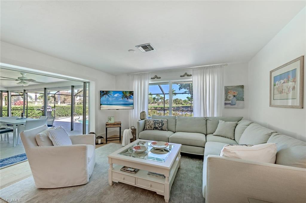 239 Torrey Pines Point Naples, FL 34113 - Photo 23 of 46 a living room with furniture and a large window