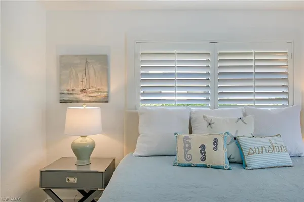 a bedroom with furniture and a window