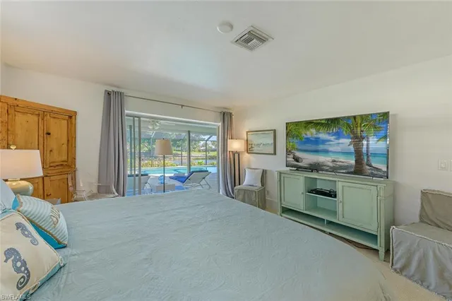 a bedroom with furniture and a flat screen tv