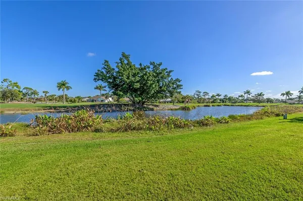 a view of a lake with houses in the background