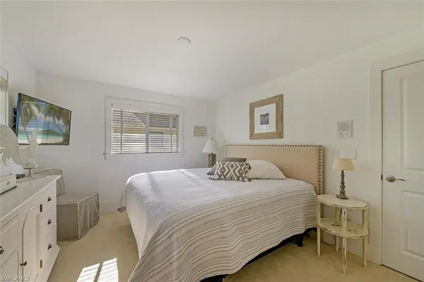 a bedroom with a bed and a table