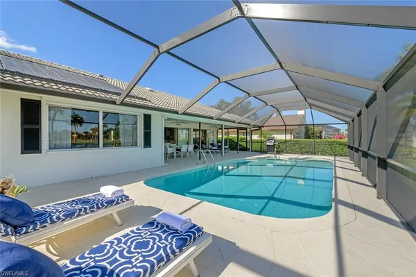 a view of a backyard with couches potted plants