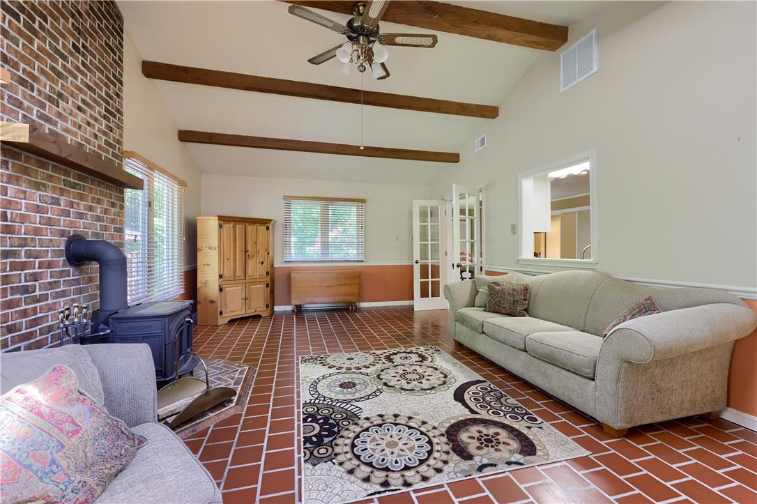 Coldsprings Rd Union Pottstown, PA 19465 - Photo 54 of 71 A relaxed living space boasts an inviting brick fireplace and lofty beamed ceilings, offering comfort and character.
