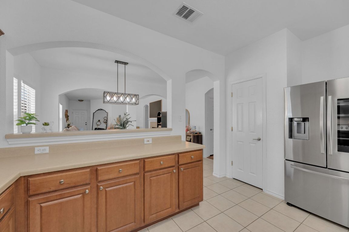 8901 Meridian Oak Lane Austin, TX 78744 - Photo 12 of 26 a kitchen with cabinets and stainless steel appliances