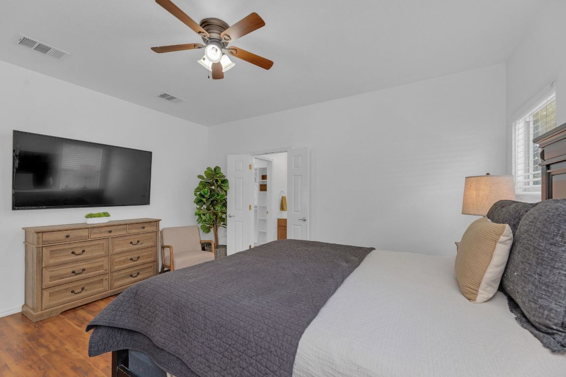 8901 Meridian Oak Lane Austin, TX 78744 - Photo 14 of 26 a bedroom with a bed and a flat screen tv
