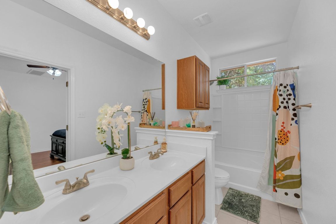 8901 Meridian Oak Lane Austin, TX 78744 - Photo 15 of 26 a bathroom with a sink double vanity and a mirror