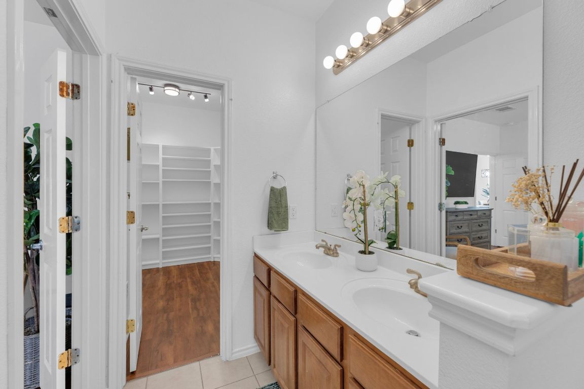 8901 Meridian Oak Lane Austin, TX 78744 - Photo 16 of 26 a bathroom with a double vanity sink and a mirror